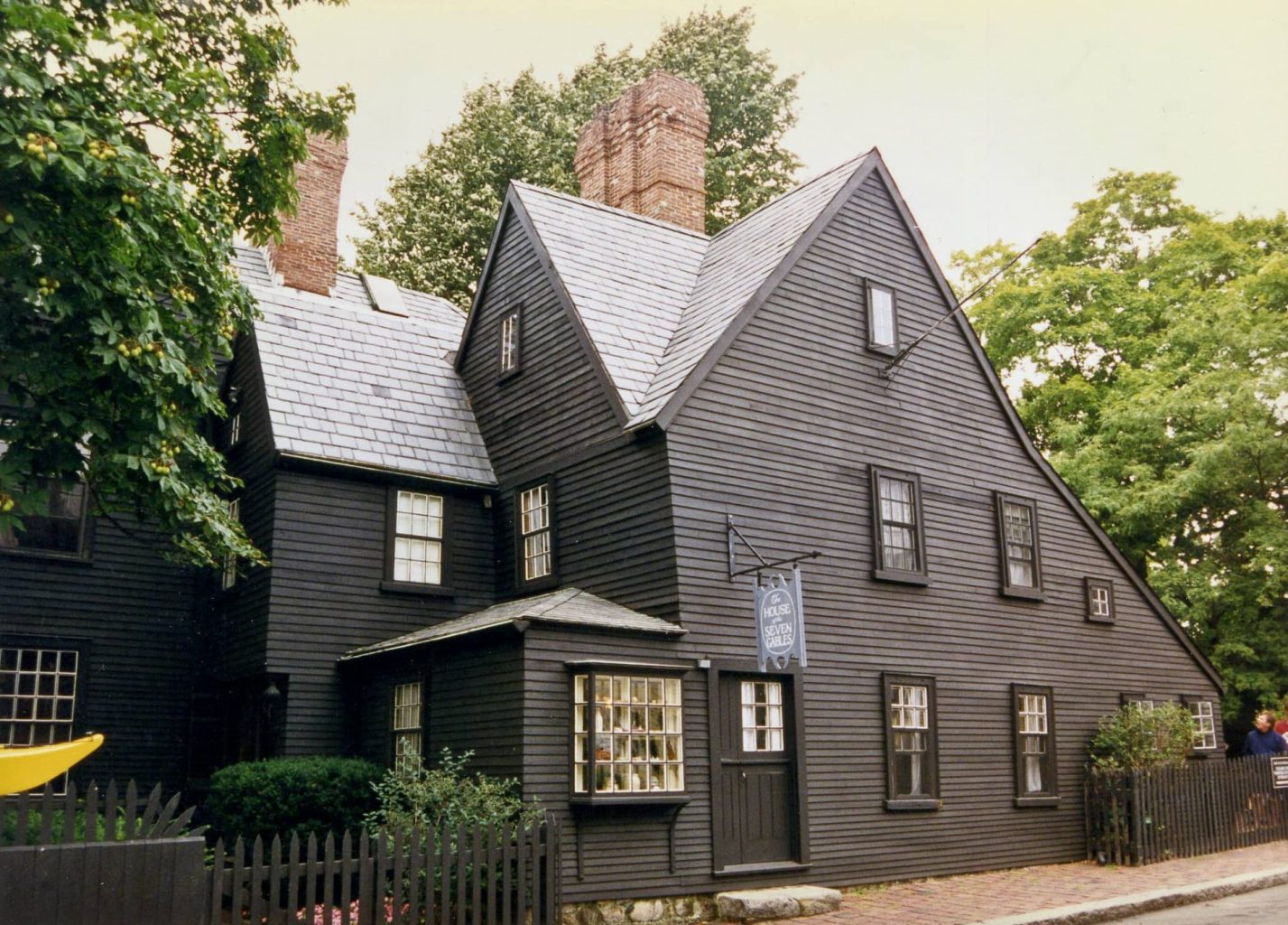House of the Seven Gables. A black house with two chimneys and a pitched roof